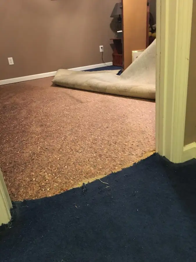 Carpet pad removal revealing water damage during Drying & Dehumidification in Howell